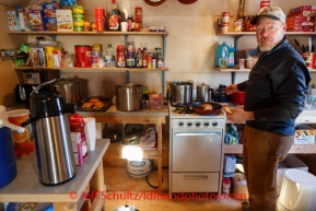 Iditarod volunteer, Brad VanMeter of South Dakota, prepares dinner for the crew at the Cripple checkpoint on Thursday, March 6, during the Iditarod Sled Dog Race 2014. VanMeter has been volunteering with the Iditarod for five years.PHOTO (c) BY JEFF SCHULTZ/IditarodPhotos.com -- REPRODUCTION PROHIBITED WITHOUT PERMISSION