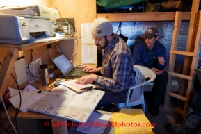 Iditarod communications personnel Mike Holland (R) and Darren Hull at the Cripple checkpoint, Thursday, March 6, during the Iditarod Sled Dog Race 2014.PHOTO (c) BY JEFF SCHULTZ/IditarodPhotos.com -- REPRODUCTION PROHIBITED WITHOUT PERMISSION