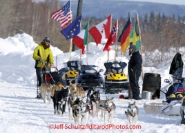 Wednesday March 7, 2012     2011 Iditarod champion John Baker watches Trent Herbst run through the Takotna checkpoint.   Iditarod 2012.