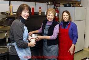 Wednesday March 7, 2012   Volunteer cooks Teri Paton, Anita Gillespie and Karen Tallent take a break from feeding the masses at the McGrath checkpoint. Iditarod 2012.