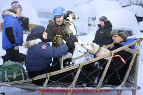 Wednesday March 7, 2012  Volunteer Randy Adkins hands a drop dog to Cassandra Winslow as Tom Marple holds onto another as the drop dog crew takes the drop dogs from the checkpoint to the airport McGrath checkpoint. Iditarod 2012.