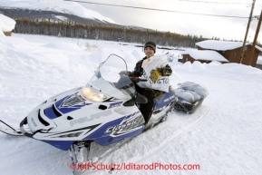 Wednesday March 7, 2012  A young resident of Takotna carries the Berington twin's musher drop bags to their parking spot at the checkpoint.  Iditarod 2012.