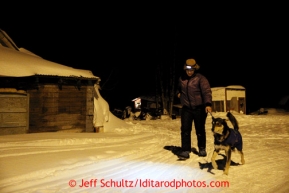 Karin Hendrickson walks a dog during her 24 hour layover at the Takotna checkpoint on Thursday March 7, 2013.Iditarod Sled Dog Race 2013Photo by Jeff Schultz copyright 2013 DO NOT REPRODUCE WITHOUT PERMISSION