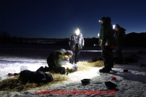 Matt Failor works with his dogs as volunteer vets look on in the evening at the halfway checkpoint of Iditarod on Thursday March 7, 2013.

Iditarod Sled Dog Race 2013

Photo by Jeff Schultz copyright 2013 DO NOT REPRODUCE WITHOUT PERMISSION