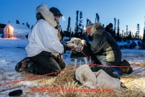 Kristi Berington talks with veterinarian Bill Sampson at the Cripple checkpoint, Friday March 7, during the Iditarod Sled Dog Race 2014.PHOTO (c) BY JEFF SCHULTZ/IditarodPhotos.com -- REPRODUCTION PROHIBITED WITHOUT PERMISSION