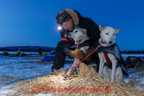 Veterinarian Glenn Behan examines Kristi Berington dogs at the Cripple checkpoint, Friday March 7, during the Iditarod Sled Dog Race 2014.PHOTO (c) BY JEFF SCHULTZ/IditarodPhotos.com -- REPRODUCTION PROHIBITED WITHOUT PERMISSION