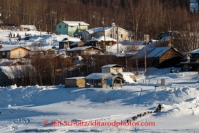 Jesse Royer runs down the bank onto the Yukon River after her 8 hour layover in Ruby on Friday, March 7, during the Iditarod Sled Dog Race 2014.PHOTO (c) BY JEFF SCHULTZ/IditarodPhotos.com -- REPRODUCTION PROHIBITED WITHOUT PERMISSION