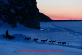 Ken Anderson runs down the bank onto the Yukon River as he leaves Ruby after sunset on Friday, March 7, during the Iditarod Sled Dog Race 2014.PHOTO (c) BY JEFF SCHULTZ/IditarodPhotos.com -- REPRODUCTION PROHIBITED WITHOUT PERMISSION