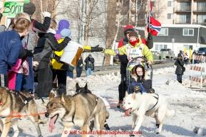 Yvonne Dabakk of Oslo, Norway runs pas spectators on Cordova Street during the cermonial start day of Iditarod 2015 in Anchorage, Alaska. Saturday March 7, 2015(C) Jeff Schultz/SchultzPhoto.com - ALL RIGHTS RESERVED DUPLICATION  PROHIBITED  WITHOUT  PERMISSION