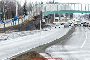 Trent Herbst crosses down the Tudor Road bridge as traffic passes under on Tudor road during the cermonial start day of Iditarod 2015 in Anchorage, Alaska. Saturday March 7, 2015(C) Jeff Schultz/SchultzPhoto.com - ALL RIGHTS RESERVED DUPLICATION  PROHIBITED  WITHOUT  PERMISSION