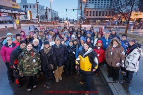 Volunteer dog handlers pose for a group photo in the morning prior to the start during the cermonial start day of Iditarod 2015. Saturday March 7, 2015(C) Jeff Schultz/SchultzPhoto.com - ALL RIGHTS RESERVED DUPLICATION  PROHIBITED  WITHOUT  PERMISSION