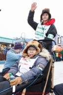 Dora Esai, the wife of honorary musher Phillip Esai, rides in the sled of Jr. Iditarod winner Ben Harper during the cermonial start day of Iditarod 2015. Saturday March 7, 2015(C) Jeff Schultz/SchultzPhoto.com - ALL RIGHTS RESERVED DUPLICATION  PROHIBITED  WITHOUT  PERMISSION