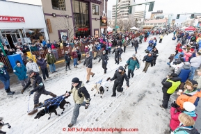 Dog handlers bring Martin Buser's team up to the start line during the cermonial start day of Iditarod 2015. Saturday March 7, 2015(C) Jeff Schultz/SchultzPhoto.com - ALL RIGHTS RESERVED DUPLICATION  PROHIBITED  WITHOUT  PERMISSION