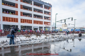 Jodi Bailey runs down 4th avenue shortly after leaving the start  line during the cermonial start day of Iditarod 2015 in Anchorage, Alaska. Saturday March 7, 2015(C) Jeff Schultz/SchultzPhoto.com - ALL RIGHTS RESERVED DUPLICATION  PROHIBITED  WITHOUT  PERMISSION