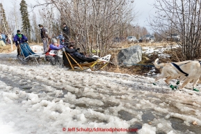 Yuka Honda runs through slushy trail conditions on the trail near the Alaska Native Hospital and Tudor Road during the cermonial start day of Iditarod 2015 in Anchorage, Alaska. Saturday March 7, 2015(C) Jeff Schultz/SchultzPhoto.com - ALL RIGHTS RESERVED DUPLICATION  PROHIBITED  WITHOUT  PERMISSION