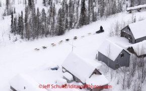 Thursday March, 2012   Justin Savidis passes old mining buildings as he travels through the historic mining district on his way to the Ophir checkpoint.   Iditarod 2012.