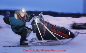 Thursday March, 2012   Jodi Bailey waves to the camera as she leaves the Takotna checkpoint in the early morning after taking her 24 hour layover.  Iditarod 2012.