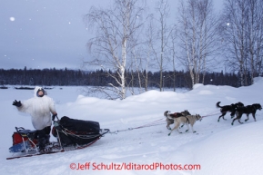 Thursday March, 2012   Jerry Sousa waves as he leaves the Takotna checkpoint.   Iditarod 2012.