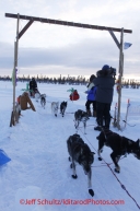 Thursday March, 2012  Lance Mackey arrives under the arch  at the Cripple checkpoint.   Iditarod 2012.