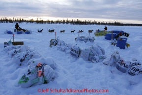 Thursday March, 2012   Aliy Zirkle mushes past the food drop bags at the Cripple checkpoint as she goes in and out of the checkpoint.   Iditarod 2012.