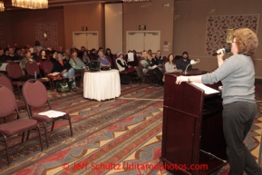 January 8, 2013  Veteran volunteer ,Jennifer Ambrose, talks with potential and returning Iditarod volunteers  at a pre-race meeting for volunteers at the Millenium Hotel Redington Ballroom to discuss postions for this year's Iditarod race to begin March 2nd in downtown Anchorage.