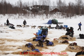 Allen Moore leaves on the Iditarod River with delapidated buildings of the ghost town of Iditarod in the background on Friday March 8, 2013.Iditarod Sled Dog Race 2013Photo by Jeff Schultz copyright 2013 DO NOT REPRODUCE WITHOUT PERMISSION