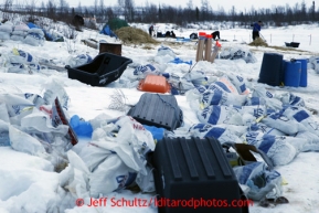 Trash and food bags line the bank of the Iditarod river at the halfway checkpoint of Iditarod on Friday March 8, 2013.Iditarod Sled Dog Race 2013Photo by Jeff Schultz copyright 2013 DO NOT REPRODUCE WITHOUT PERMISSION