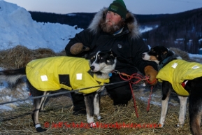 Volunteer helper and checker Josh Capps holds Rick Casillo dogs as Rick prepares to leave Ruby on Saturday March 8, during the Iditarod Sled Dog Race 2014.PHOTO (c) BY JEFF SCHULTZ/IditarodPhotos.com -- REPRODUCTION PROHIBITED WITHOUT PERMISSION