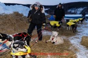 Volunteer checker and former ITC executive director Raine Hall along with Josh Capps and judge Kevin Saiki help get Rick Casillo dogs out of their parking spot in Ruby on Saturday March 8, during the Iditarod Sled Dog Race 2014.PHOTO (c) BY JEFF SCHULTZ/IditarodPhotos.com -- REPRODUCTION PROHIBITED WITHOUT PERMISSION