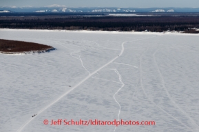 Jason Mackey , Karin Hendrickson and Justin Savidas on the Yukon just before Galena , in the background on Saturday March 8, during the Iditarod Sled Dog Race 2014.PHOTO (c) BY JEFF SCHULTZ/IditarodPhotos.com -- REPRODUCTION PROHIBITED WITHOUT PERMISSION