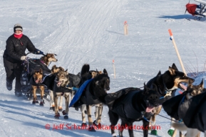 Jessie Royer runs up the bank of the Yukon River to Kaltag with her dog Yukon in the basket on Saturday March 8, during the Iditarod Sled Dog Race 2014.PHOTO (c) BY JEFF SCHULTZ/IditarodPhotos.com -- REPRODUCTION PROHIBITED WITHOUT PERMISSION