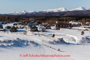 Wade Marrs runs up the Yukon River bank and into Kaltag on Saturday March 8, during the Iditarod Sled Dog Race 2014.PHOTO (c) BY JEFF SCHULTZ/IditarodPhotos.com -- REPRODUCTION PROHIBITED WITHOUT PERMISSION