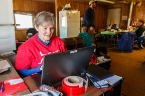 Volunteer Comms Lynne Danielson works at Kaltag on Saturday March 8, during the Iditarod Sled Dog Race 2014.PHOTO (c) BY JEFF SCHULTZ/IditarodPhotos.com -- REPRODUCTION PROHIBITED WITHOUT PERMISSION