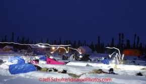 Friday March 9, 2012   Mushers headlamps makes streaks in this time-exposure asthey tend to their dogs at the half-way checkpoint at Cripple.   Iditarod 2012.