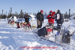 Friday March 9, 2012   Race Judge Jim Gallea checks in Ed Stielstra as vets look over the dogs on his brief stop at the half-way checkpoint at Cripple.   Iditarod 2012.