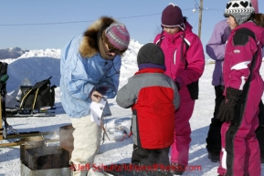 Friday March 9, 2012  DeeDee Jonrowe signs autographs for kids at the Yukon River village of Ruby, Alaska. Iditarod 2012.