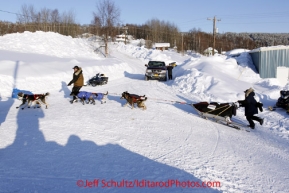 Friday March 9, 2012  Anjanette Steer runs behind her sled to make a wide turn to a parking spot as she arrives in the Yukon River village of Ruby, Alaska. Iditarod 2012.