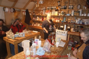 Friday March 9, 2012  Volunteer cook Deb Symanski cooks breakfast inside her cook shack at the half-way checkpoint at Cripple.   Iditarod 2012.