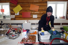 Friday March 9, 2012   Volunteer veterinarian Melissa Diederich helps with the cleaning chores inside the community center checkpoint at Ruby.  Iditarod 2012.