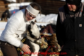 Veterinarian Julie Kittams, left, and Gerald Soua's dog Mar at the Shageluk checkpoint on Saturday March 9, 2013.Iditarod Sled Dog Race 2013Photo by Jeff Schultz copyright 2013 DO NOT REPRODUCE WITHOUT PERMISSION