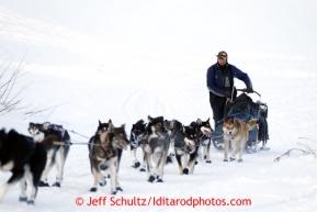 Sonny Lindner walks with his sled off the Yukon River and up the bank to the Kaltag checkpoint on Saturday March 9, 2013.Iditarod Sled Dog Race 2013Photo by Jeff Schultz copyright 2013 DO NOT REPRODUCE WITHOUT PERMISSION