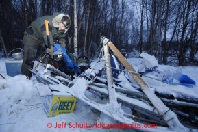 Michael Suprenant chips ice off his sled at the halfway checkpoint of Iditarod on Saturday March 9, 2013.Iditarod Sled Dog Race 2013Photo by Jeff Schultz copyright 2013 DO NOT REPRODUCE WITHOUT PERMISSION