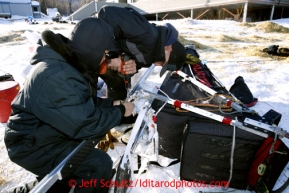 David Walker and Bernard Edwards help repair Jodi Bailey's sled at the Shageluk checkpoint on Saturday March 9, 2013.Iditarod Sled Dog Race 2013Photo by Jeff Schultz copyright 2013 DO NOT REPRODUCE WITHOUT PERMISSION