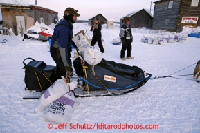 Sonny Lindner grabs his dog food bags after checking in at the Kaltag checkpoint on Saturday March 9, 2013.Iditarod Sled Dog Race 2013Photo by Jeff Schultz copyright 2013 DO NOT REPRODUCE WITHOUT PERMISSION