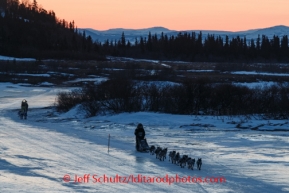 Pete Kaiser leads Wade Marrs on the Unalakleet River at sunrise on the way in to Unalakleet on Sunday, March 9, during the Iditarod Sled Dog Race 2014.PHOTO (c) BY JEFF SCHULTZ/IditarodPhotos.com -- REPRODUCTION PROHIBITED WITHOUT PERMISSION