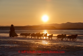 Richie Diehl on the Unalakleet River on the way into Unalakleet at sunrise on Sunday, March 9, during the Iditarod Sled Dog Race 2014.PHOTO (c) BY JEFF SCHULTZ/IditarodPhotos.com -- REPRODUCTION PROHIBITED WITHOUT PERMISSION