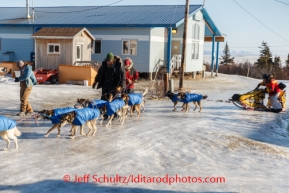 Mitch Seavey gets help moving and parking his team on the glare ice road at Koyuk on Sunday, March 9, during the Iditarod Sled Dog Race 2014.PHOTO (c) BY JEFF SCHULTZ/IditarodPhotos.com -- REPRODUCTION PROHIBITED WITHOUT PERMISSION