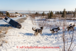 Aliy Zirkle 's sled tips as she is guiding her team to the trail at Koyuk on Sunday, March 9, during the Iditarod Sled Dog Race 2014.PHOTO (c) BY JEFF SCHULTZ/IditarodPhotos.com -- REPRODUCTION PROHIBITED WITHOUT PERMISSION