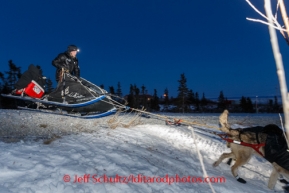 Dallas Seavey on one runner as he crosses a road with glare ice on his way out of Koyuk on Sunday, March 9, during the Iditarod Sled Dog Race 2014.PHOTO (c) BY JEFF SCHULTZ/IditarodPhotos.com -- REPRODUCTION PROHIBITED WITHOUT PERMISSION