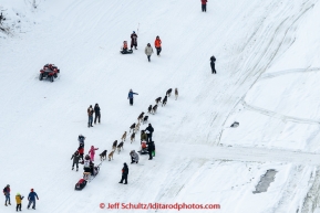 Aaron Burmeister gives high-fives to spectator on the Chena river after leaving the start line at Pike's Landing in Fairbanks on Monday March 9, 2015 during Iditarod 2015.(C) Jeff Schultz/SchultzPhoto.com - ALL RIGHTS RESERVED DUPLICATION  PROHIBITED  WITHOUT  PERMISSION